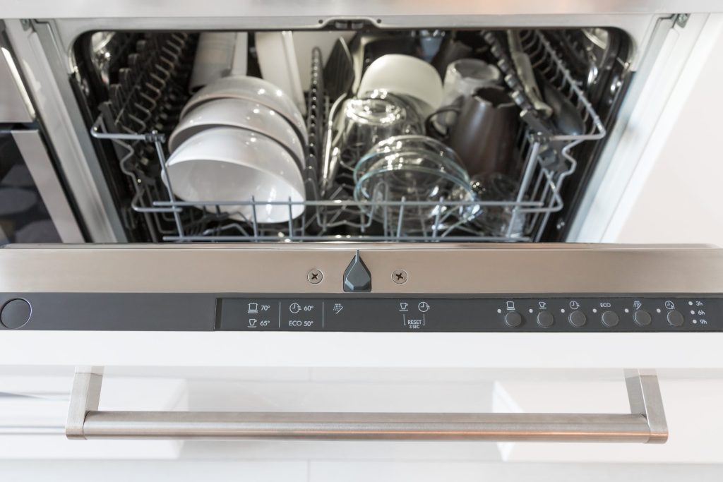 The control strip above a semi-integrated dishwasher door, program symbols and a bar handle below