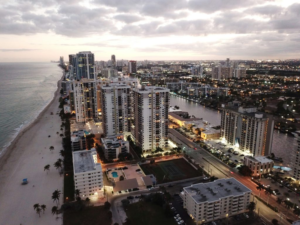 Condominium towers along the beach at dusk, seen from the air