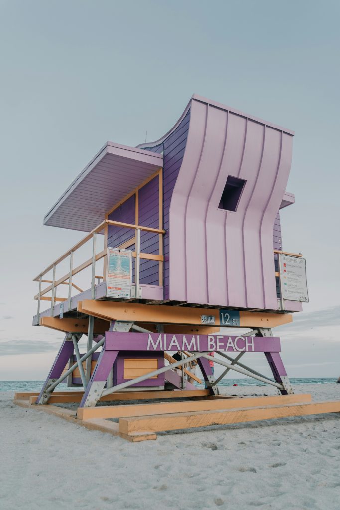 A pink and lilac lifeguard tower on the sand at Miami Beach